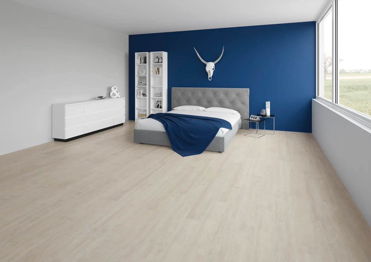 JOKA Design 340 Dryback 2827 Sky Oak Klebevinyl im Schlafzimmer mit blauer Akzentwand, grauem Bett und weißem Sideboard